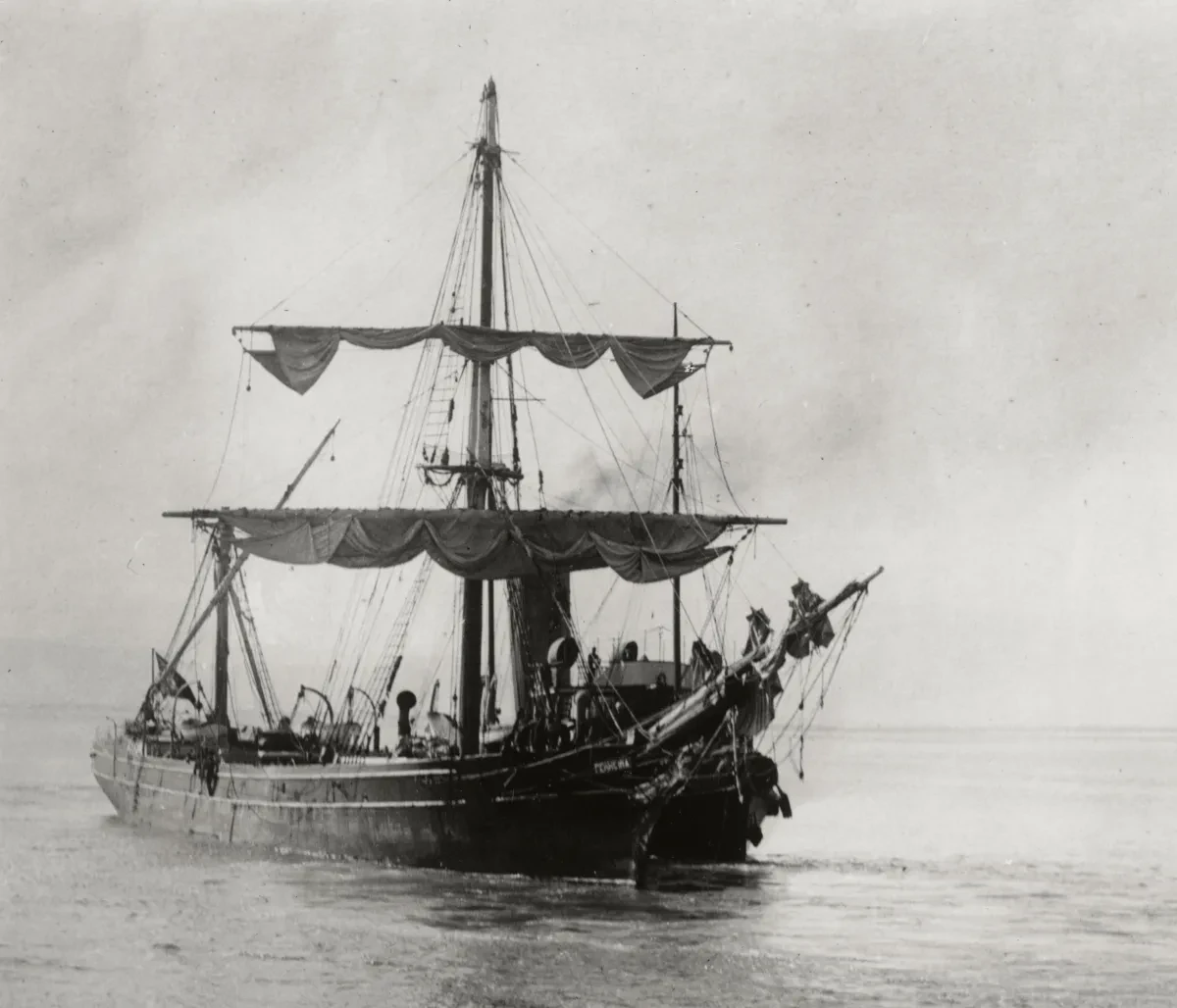 A black and white photograph of a large sailing ship at sea.