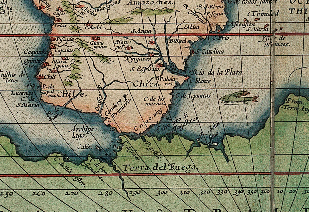 Close up detail of a hand coloured map of the world showing a flying fish