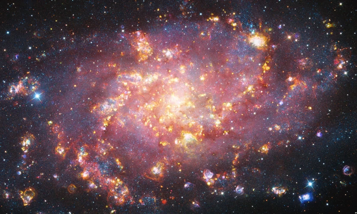 Brightly coloured emission nebulae in a dark sky.