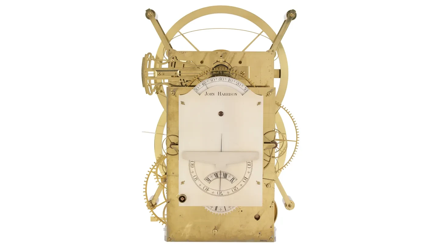 A brass timekeeping instrument with the name John Harrison.