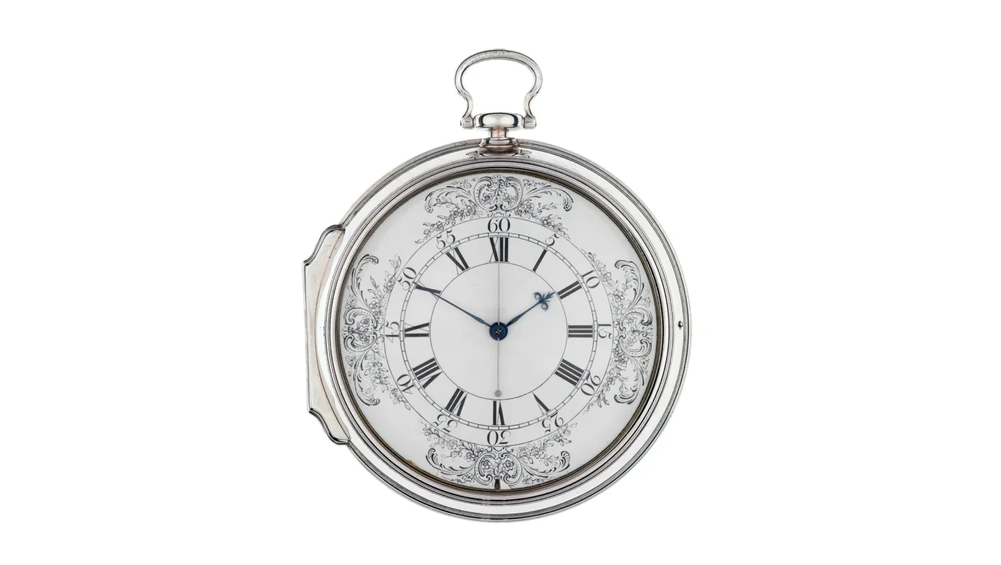 Silver casing and black and white face of a Harrison timepiece.
