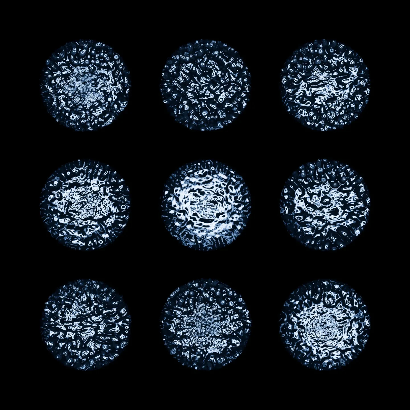 Image showing black background with 9 individually spaced circles of blue water in different patters