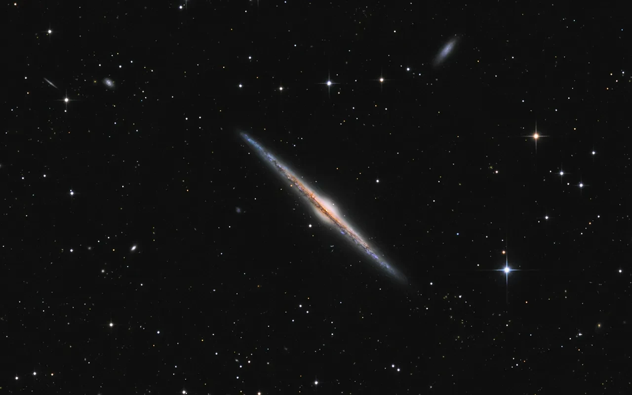 A galaxy in a starry black sky.