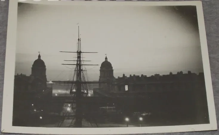 Old photo showing the sky above Greenwich lit with a bright white glow.